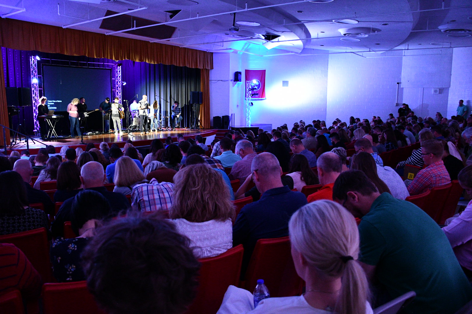 The Hope Church congregation worshiping together in the Daniel Boone High School auditorium