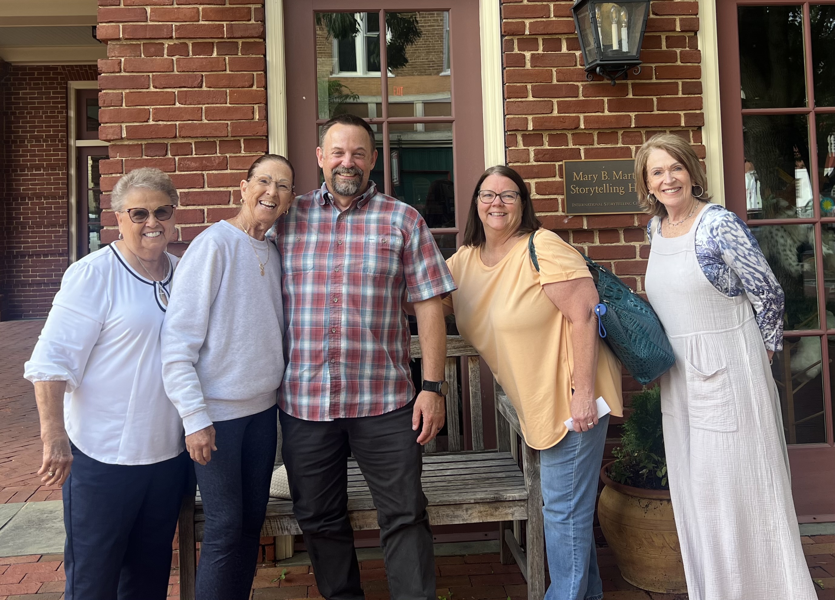 Five Fueled by Hope friends posing together outside the Mary B. Martin Storytelling Hall in downtown Jonesborough