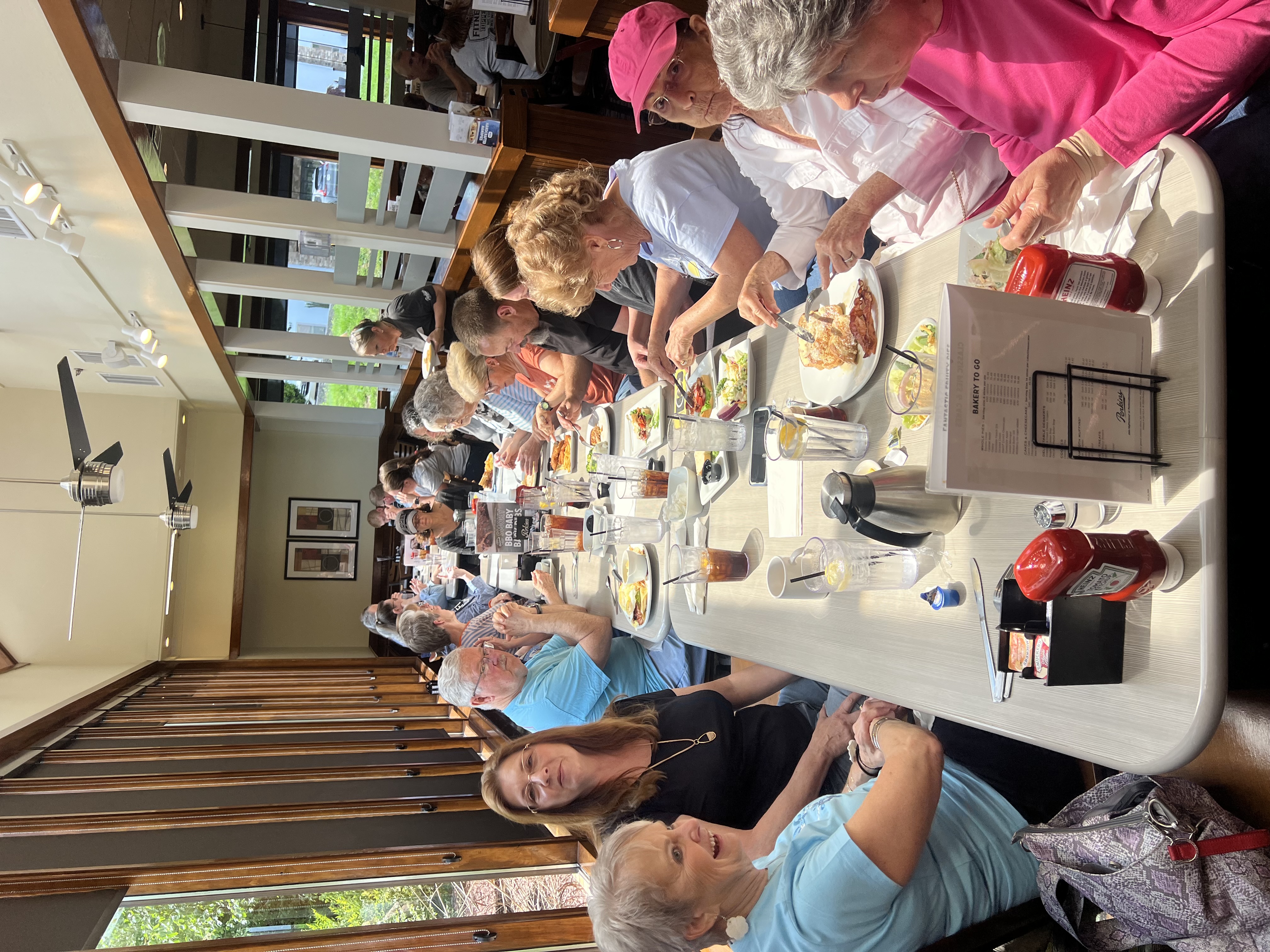 A long restaurant table filled with Fueled by Hope members sharing a meal together at Perkins