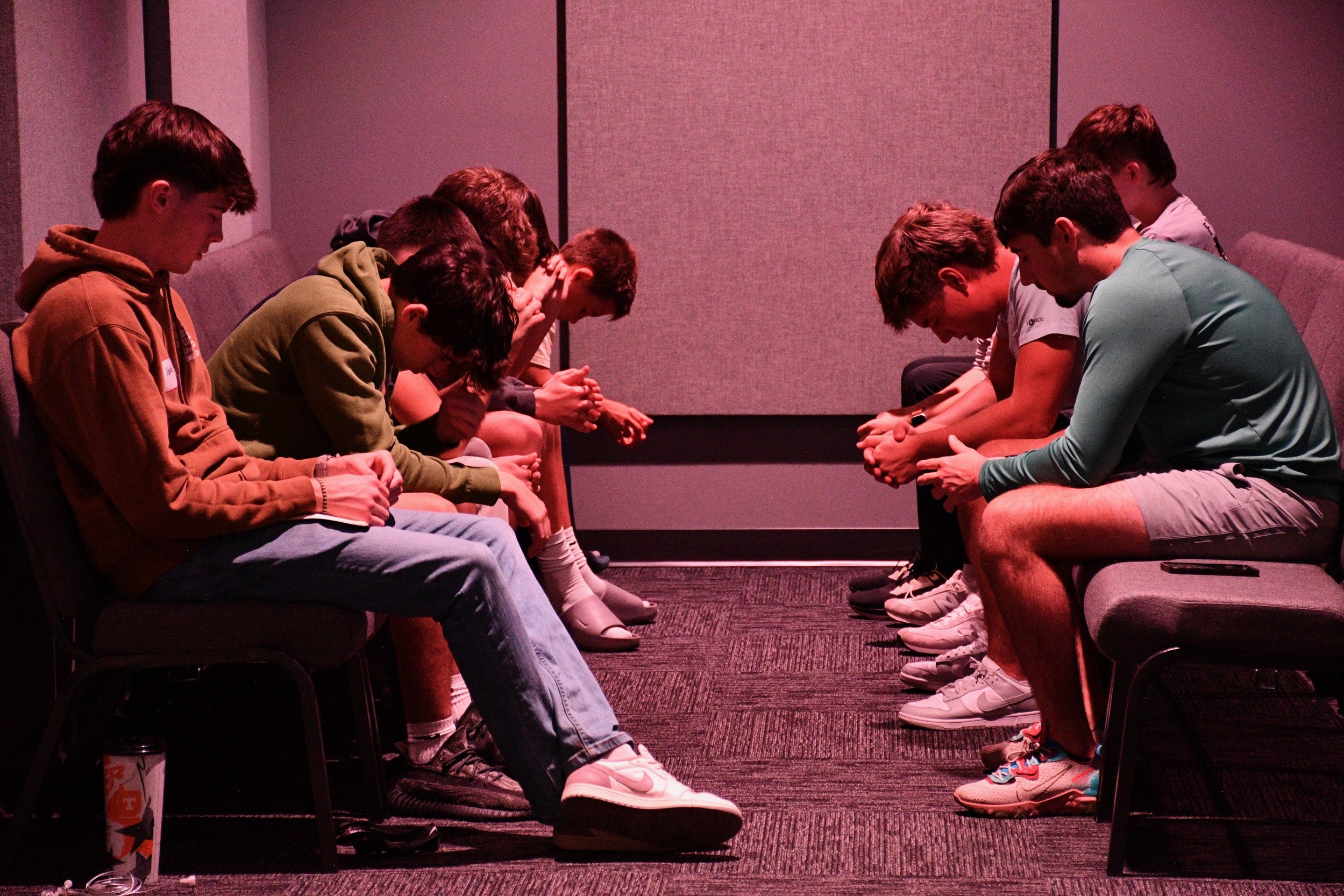 A group of students praying together in a circle