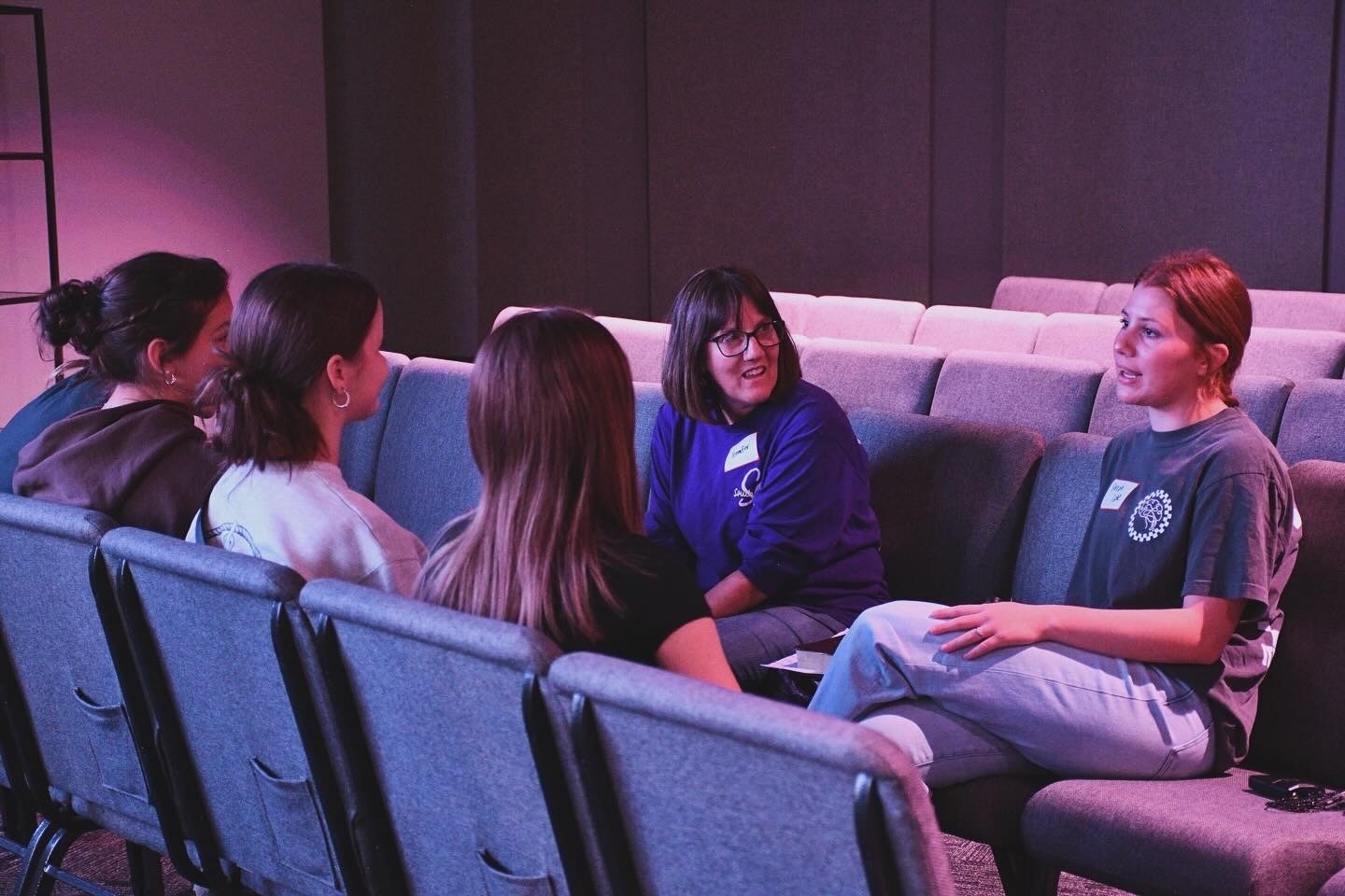 A girls' small group in conversation with a leader