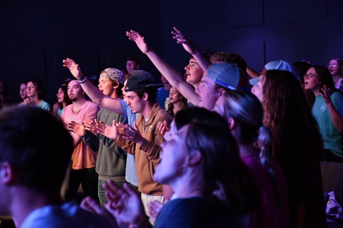Hope Students worshipping with arms raised